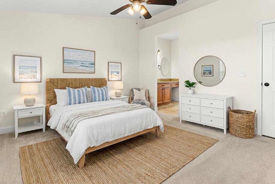 6081 Heliconia Road Delray Beach, FL 33484 - Photo 21 of 39 a bedroom with a bed a chandelier and a dresser