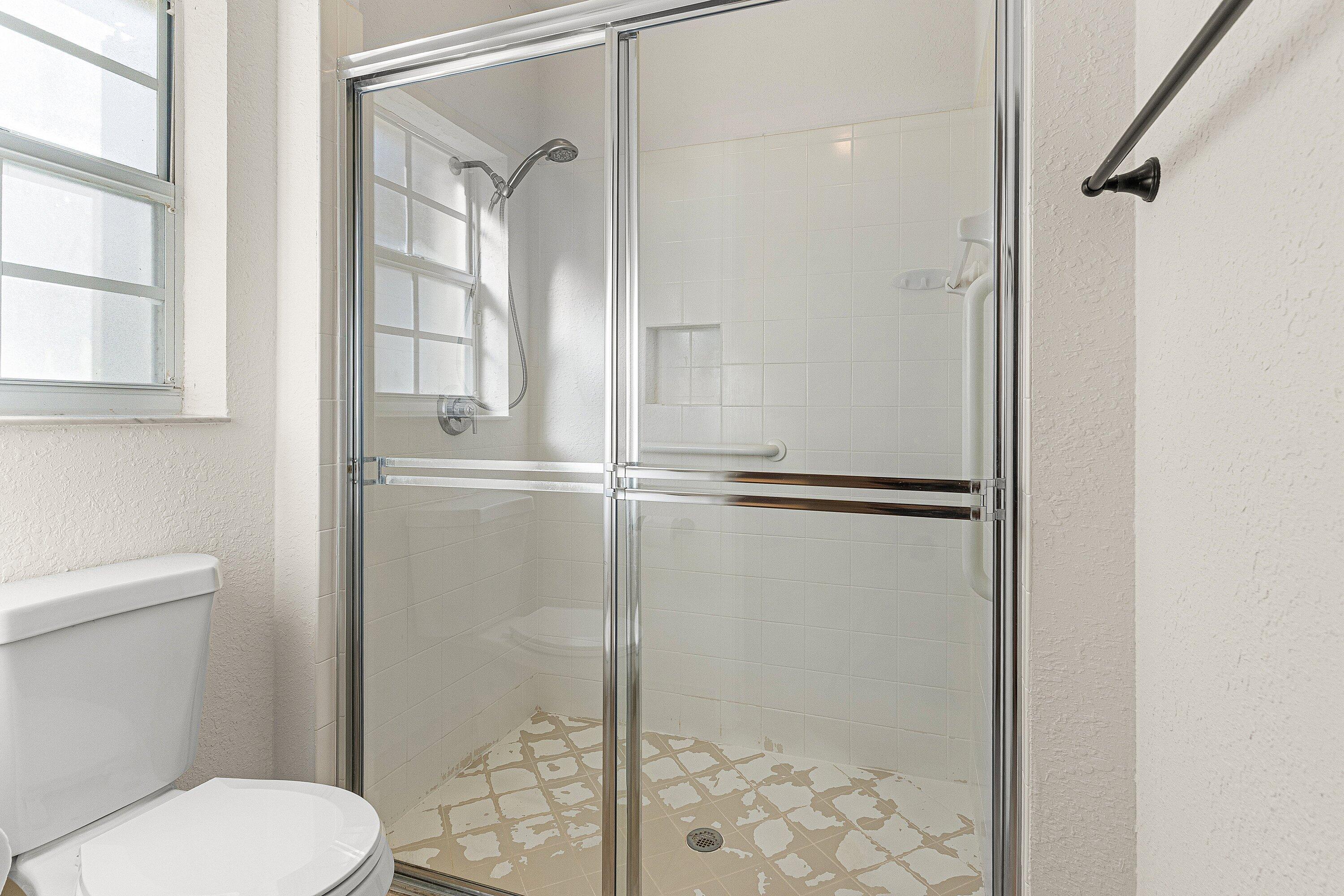 6081 Heliconia Road Delray Beach, FL 33484 - Photo 24 of 39 a bathroom with a toilet and a shower