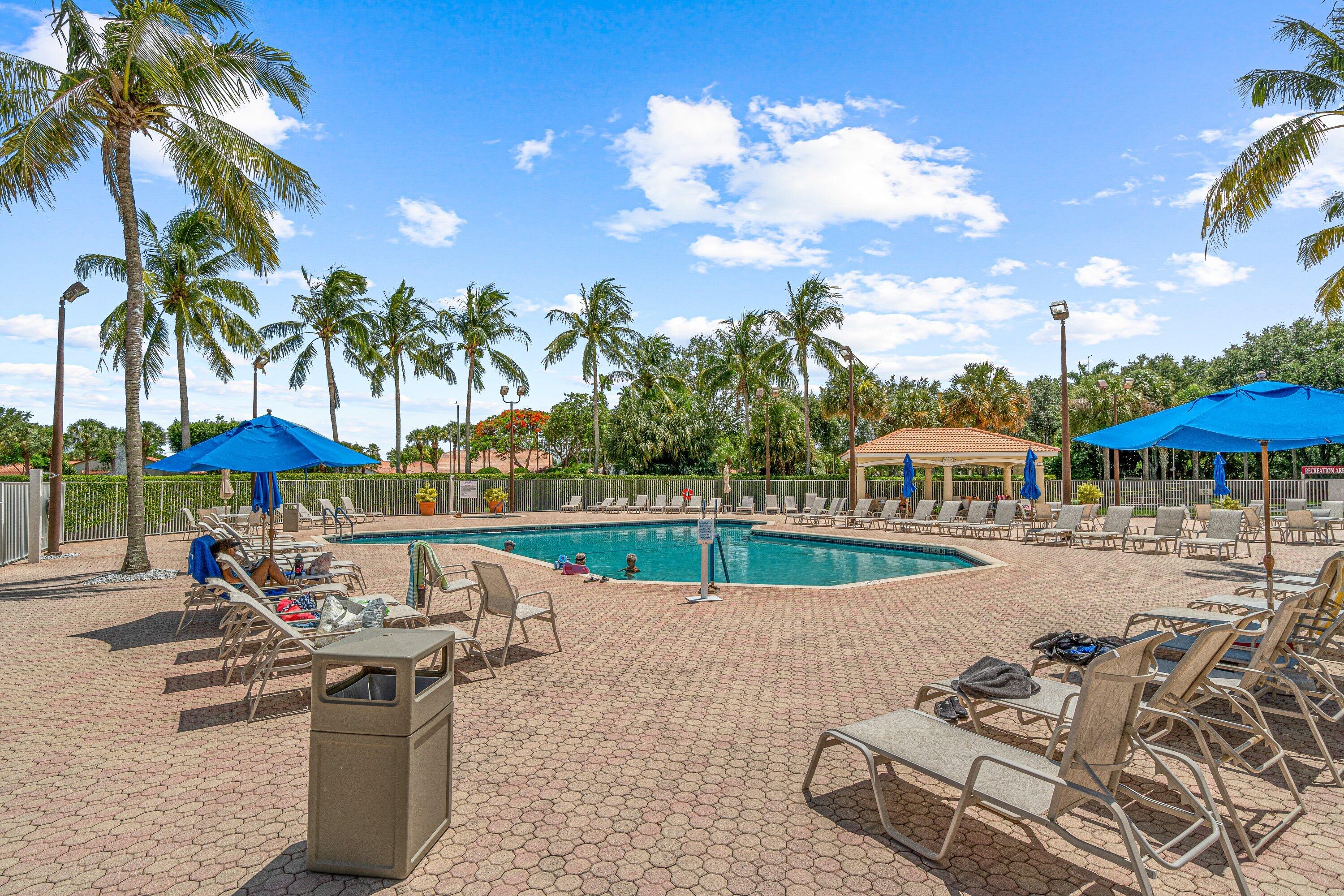 6081 Heliconia Road Delray Beach, FL 33484 - Photo 34 of 39 a view of a swimming pool with lounge chairs