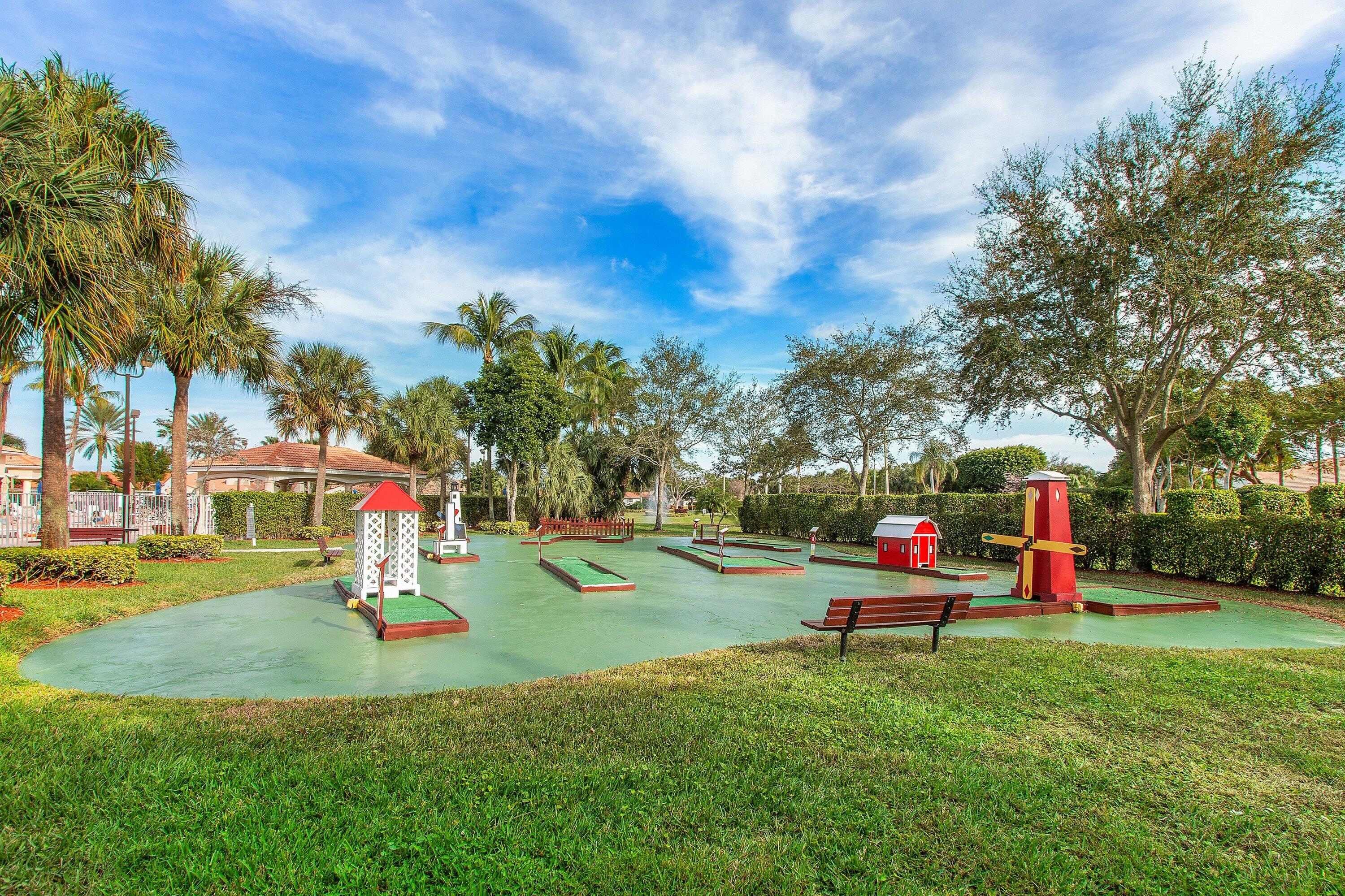 6081 Heliconia Road Delray Beach, FL 33484 - Photo 38 of 39 a childrens park with lots of swings and slides