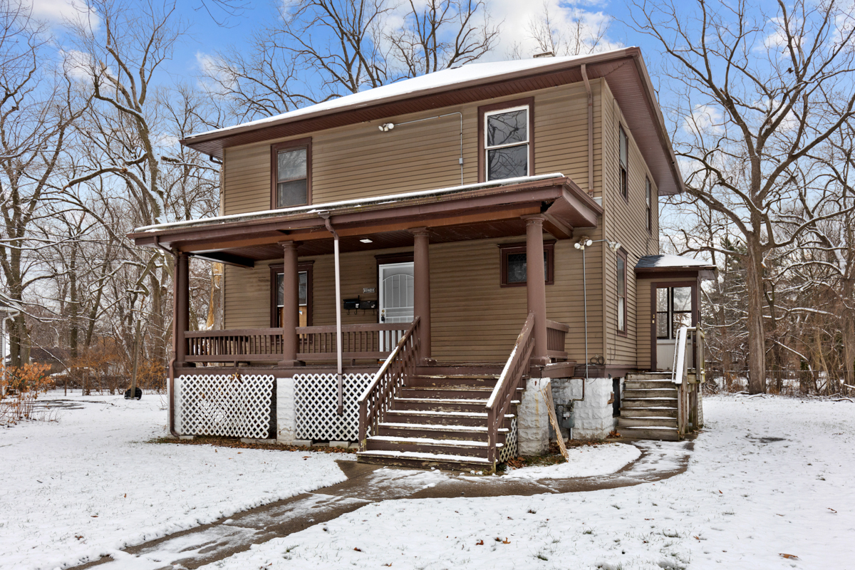 16746 Lincoln Street Hazel Crest, IL 60429 - Photo 1 of 20 a front view of a house with a floor to ceiling windows and a large tree