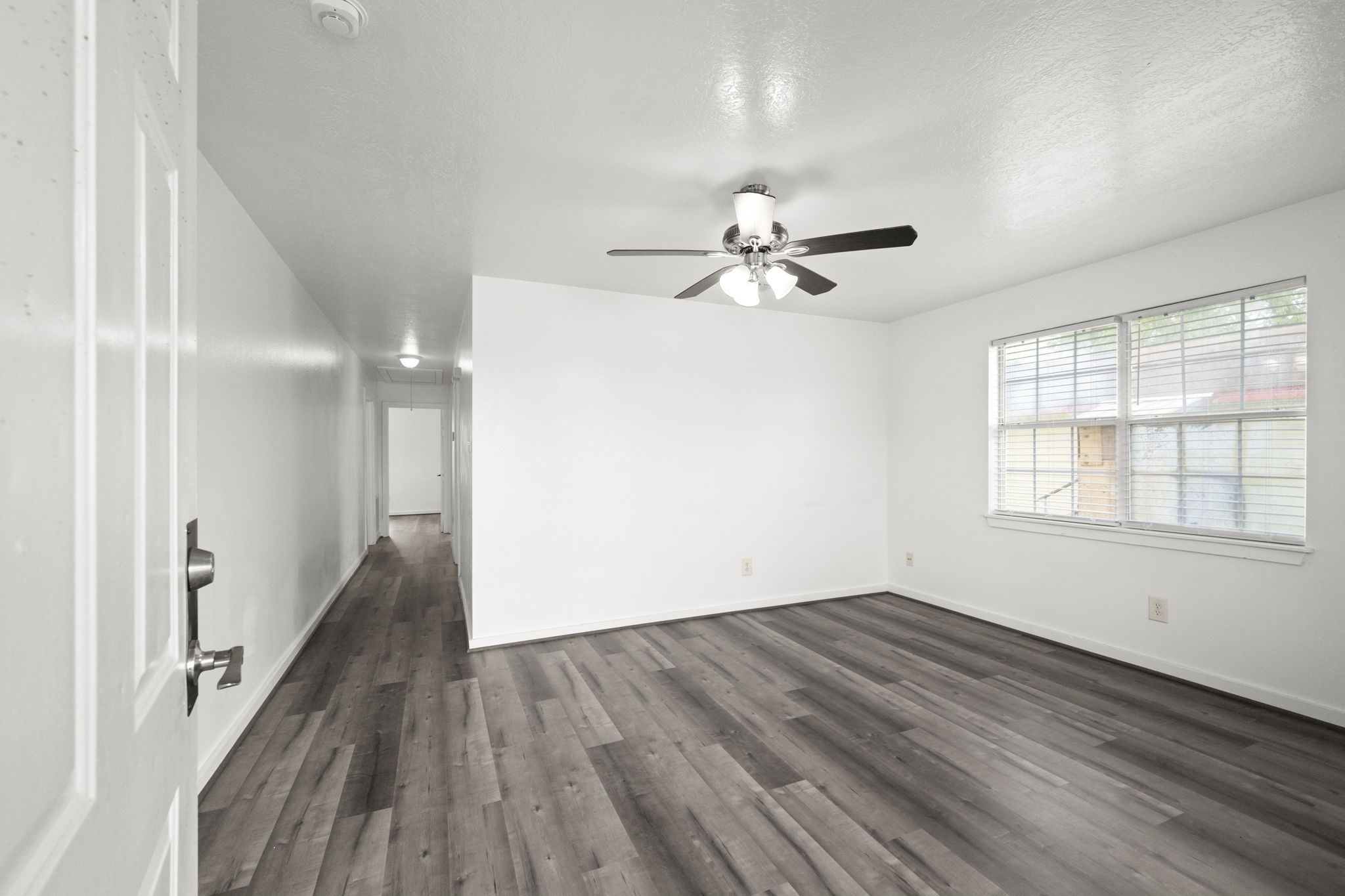 1935 1st Street Hempstead, TX 77445 - Photo 12 of 29 a view of a room with wooden floor and a ceiling fan