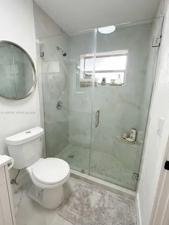 a bathroom with a sink a toilet and mirror