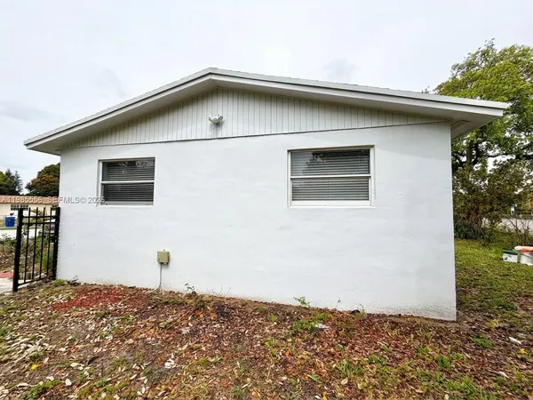 a front view of house with yard and trees