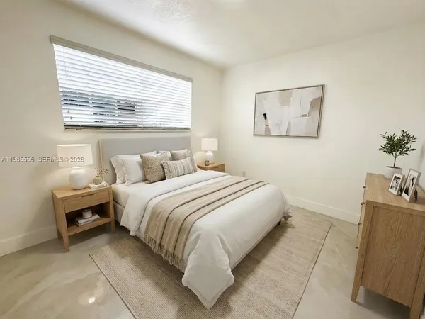 a bedroom with a bed and a window