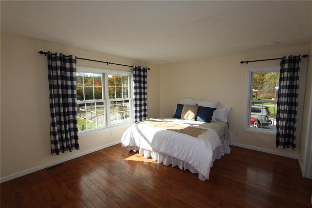 169 Wilpen Road Ligonier, PA 15658 - Photo 12 of 49 a bedroom with a bed and wooden floor