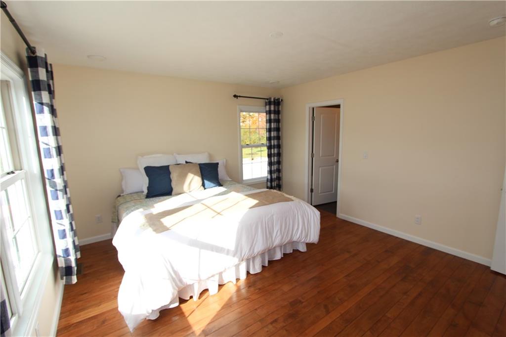 169 Wilpen Road Ligonier, PA 15658 - Photo 13 of 49 a bedroom with a bed and wooden floor