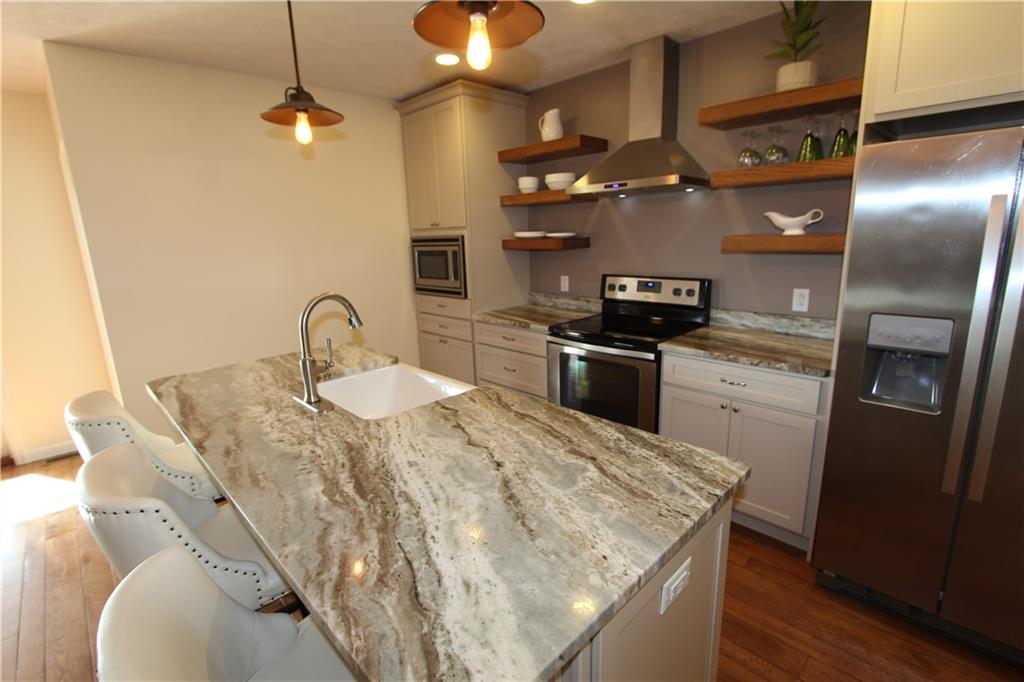 169 Wilpen Road Ligonier, PA 15658 - Photo 20 of 49 a kitchen with stainless steel appliances granite countertop a sink a stove and refrigerator