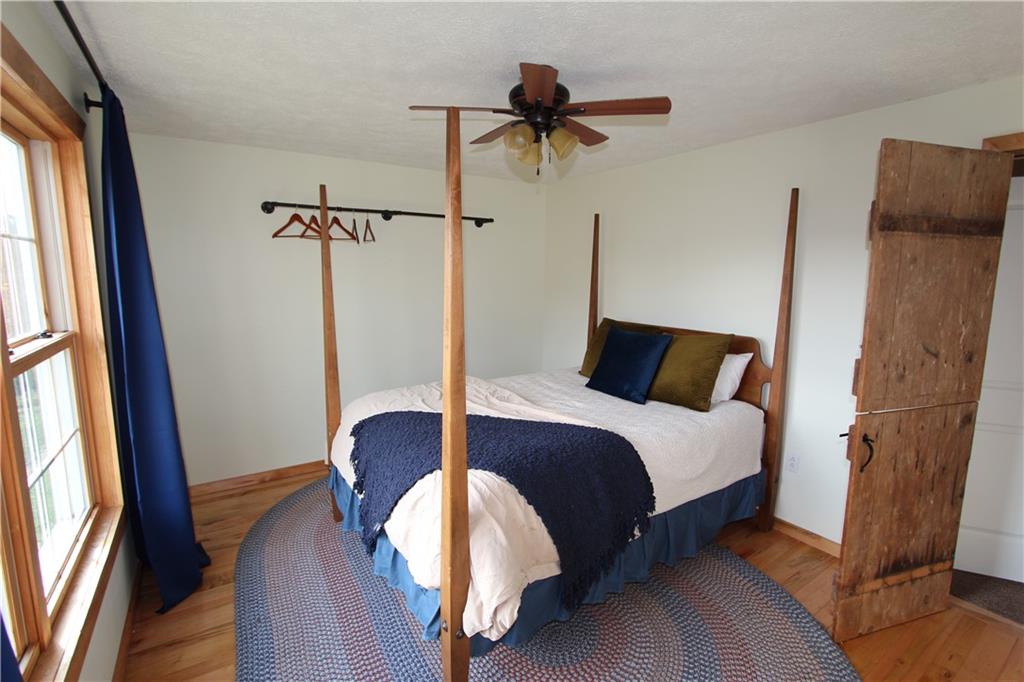 169 Wilpen Road Ligonier, PA 15658 - Photo 28 of 49 a bedroom with a bed and a large mirror next to a window