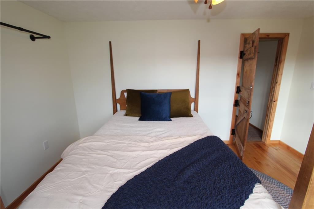 169 Wilpen Road Ligonier, PA 15658 - Photo 29 of 49 a bedroom with a bed and a flat tv screen on the dresser