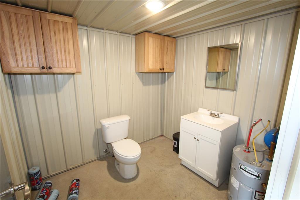 169 Wilpen Road Ligonier, PA 15658 - Photo 40 of 49 a white toilet sitting next to a bathroom sink and vanity