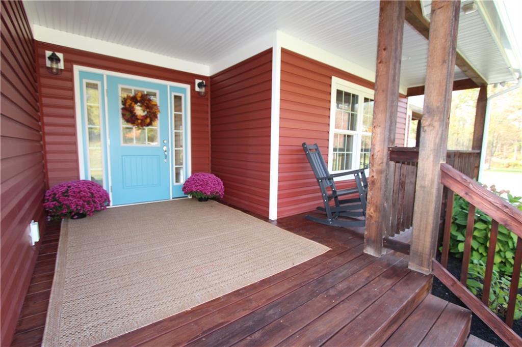 169 Wilpen Road Ligonier, PA 15658 - Photo 4 of 49 a view of a porch with wooden floor and a floor to ceiling window