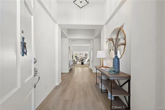 a view of a hallway to a livingroom and a dining room with wooden floor