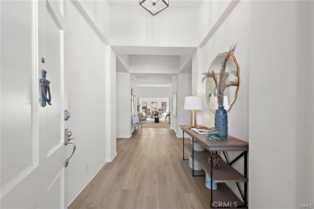 a view of a hallway to a livingroom and a dining room with wooden floor
