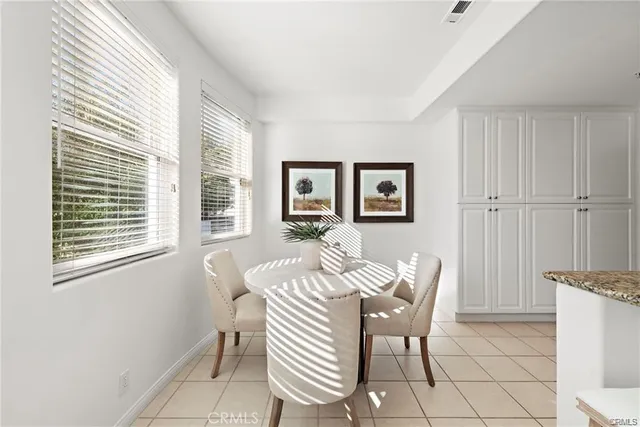 a dining room with furniture and window