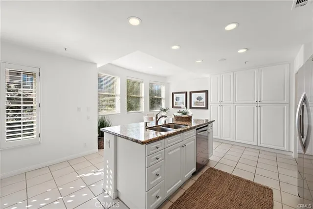 a kitchen with granite countertop a sink and cabinets