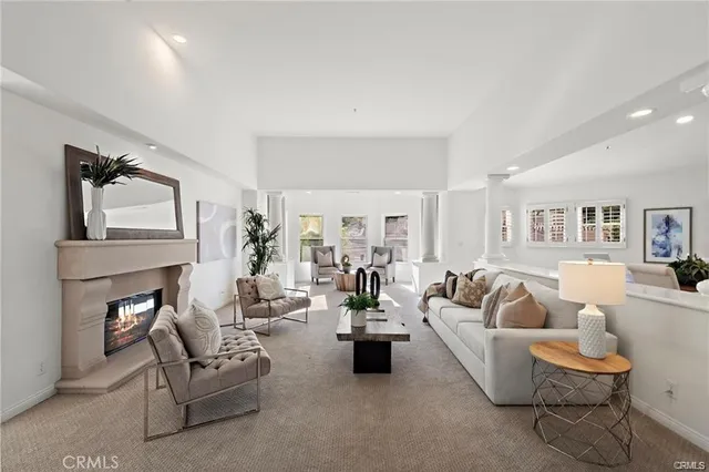 a living room with fireplace furniture and a wooden floor