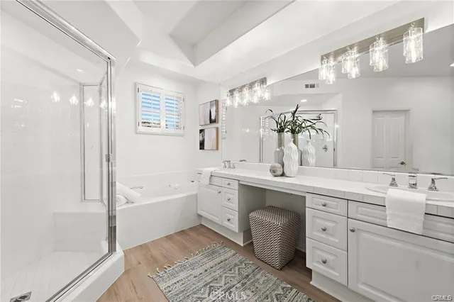 a spacious bathroom with a bathtub sink and mirror