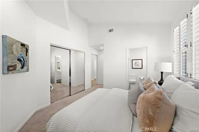 a bedroom with a bed and a lamp