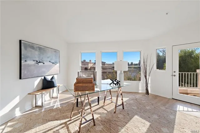 a living room with furniture and a dining table with kitchen view