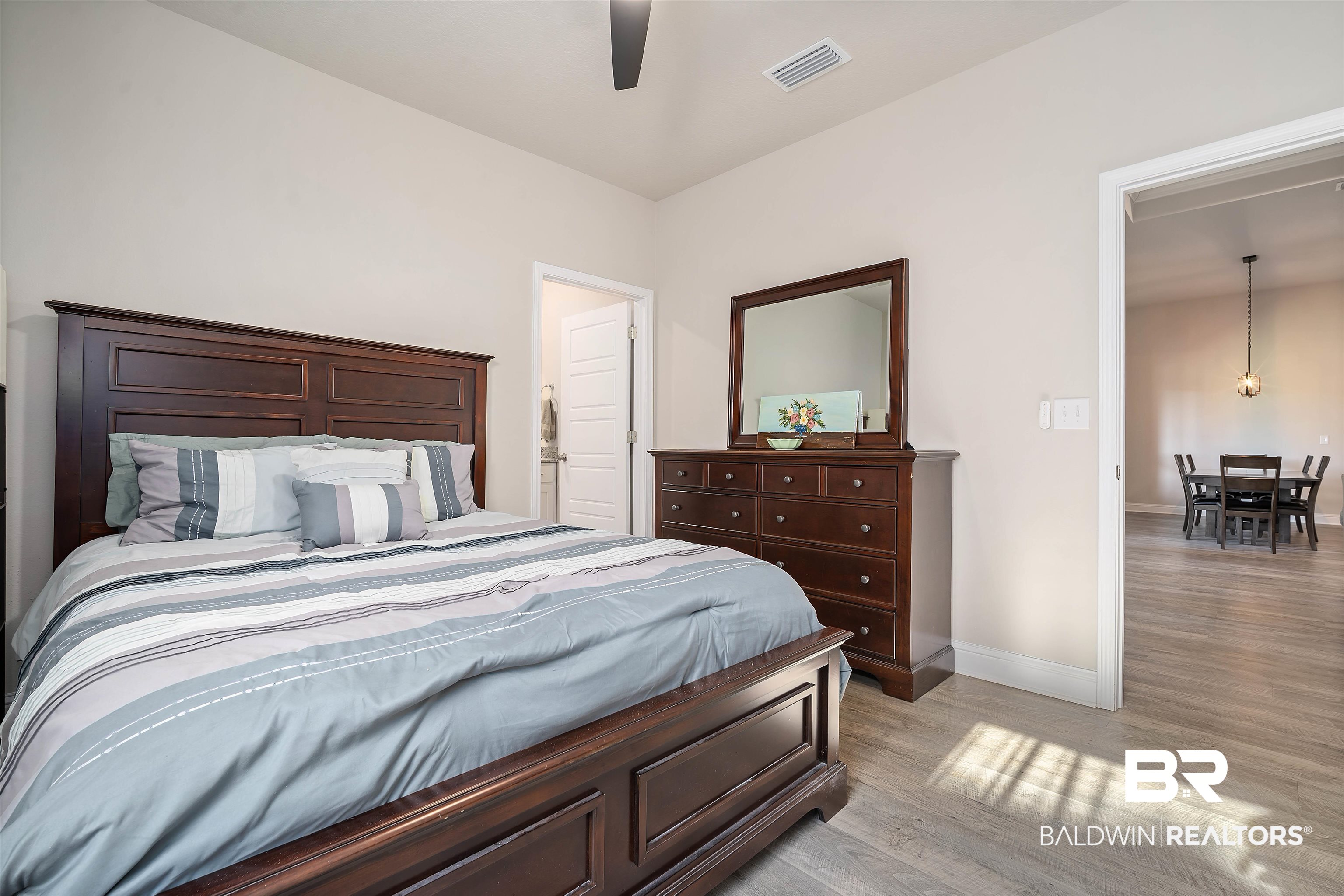 1700 Gwin Court Mobile, AL 36695 - Photo 28 of 36 Bedroom featuring light wood-type flooring, connected bathroom, and a ceiling fan