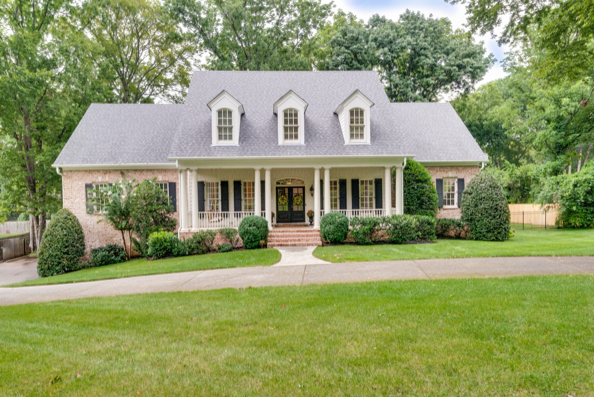 114 Cheek Road Nashville, TN 37205 - Photo 1 of 50 a front view of a house with a yard and porch