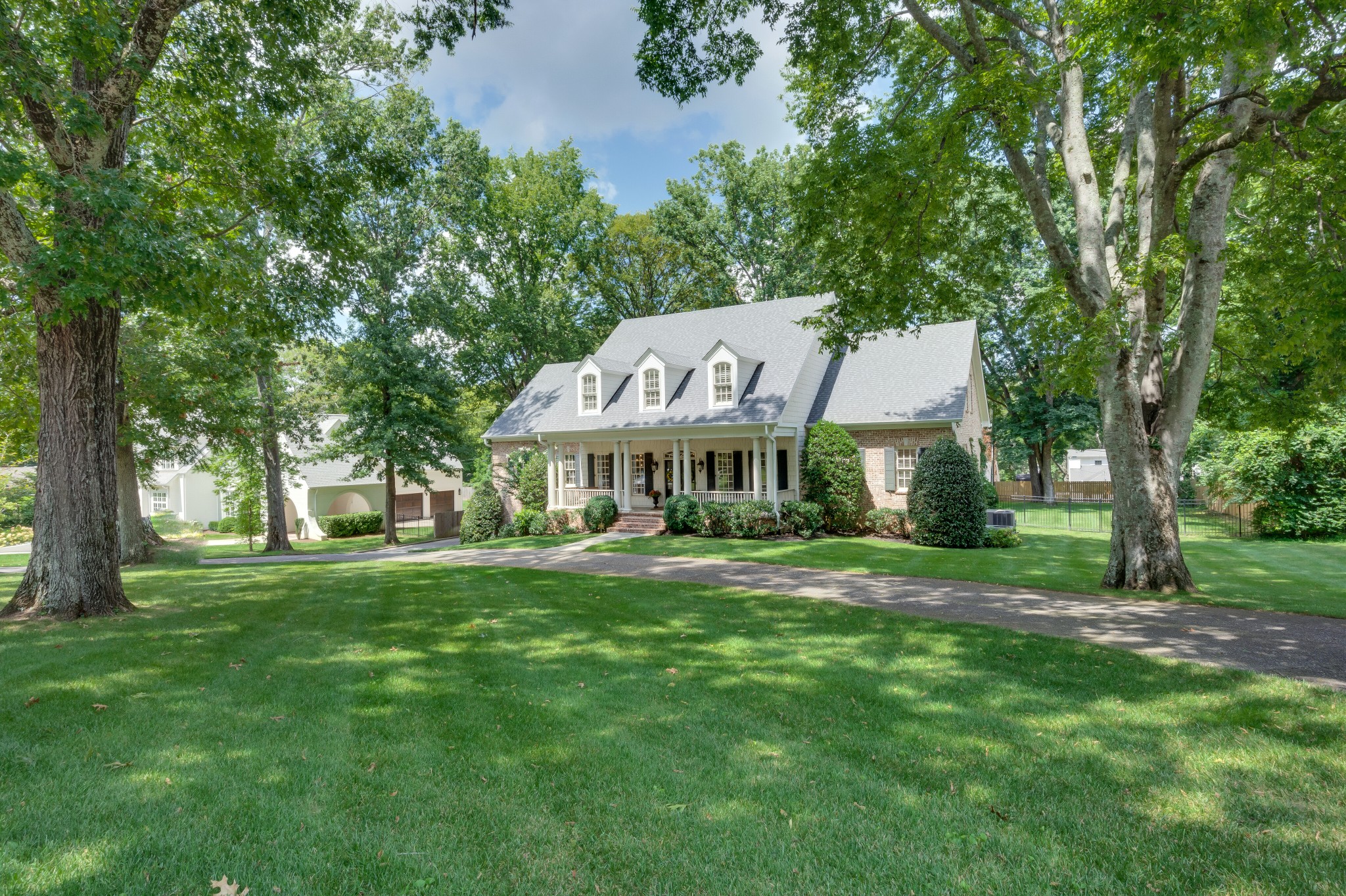114 Cheek Road Nashville, TN 37205 - Photo 2 of 50 a front view of a house with a garden