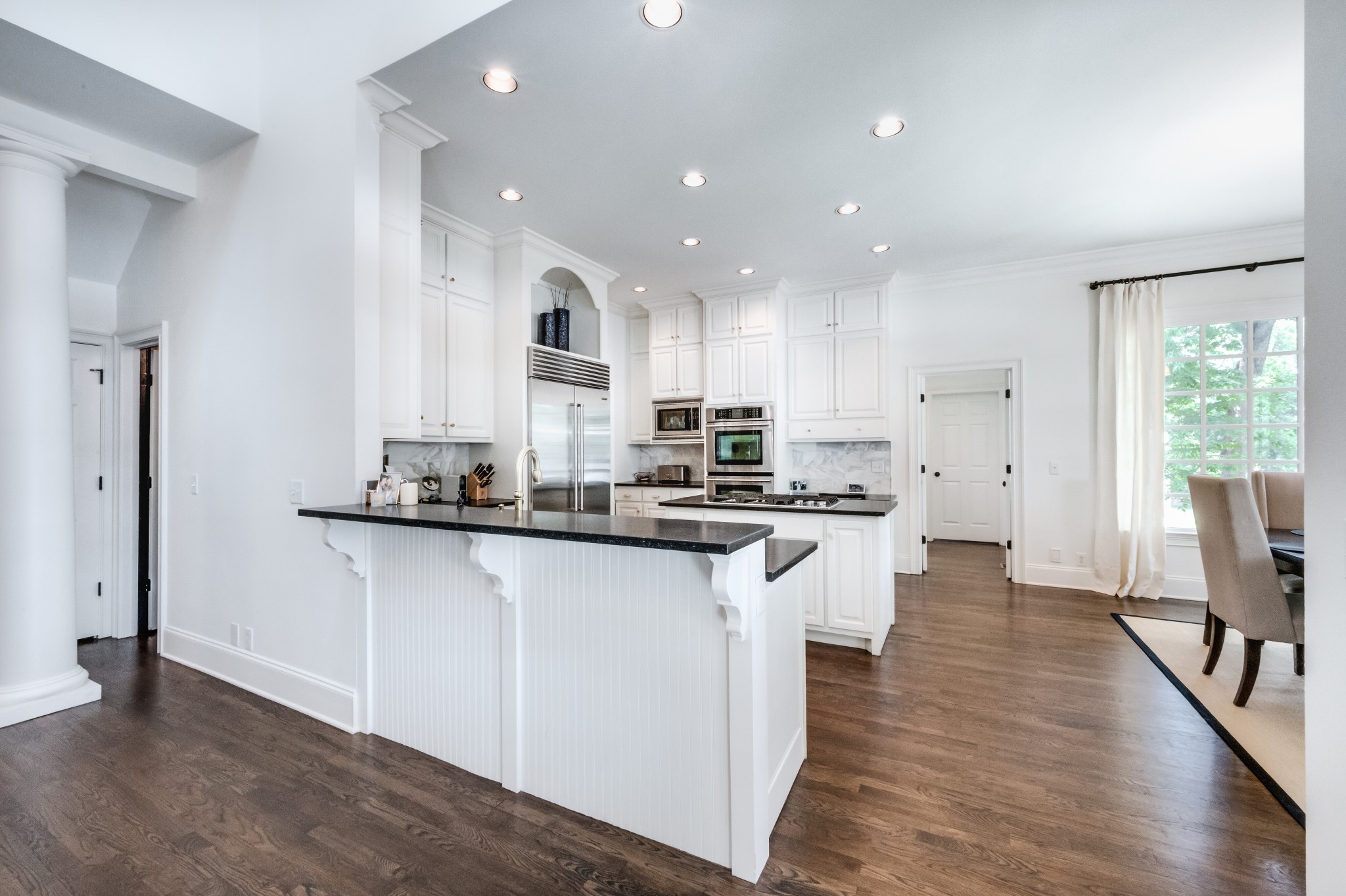 114 Cheek Road Nashville, TN 37205 - Photo 14 of 50 a kitchen with stainless steel appliances granite countertop wooden floor a refrigerator a sink and white cabinets