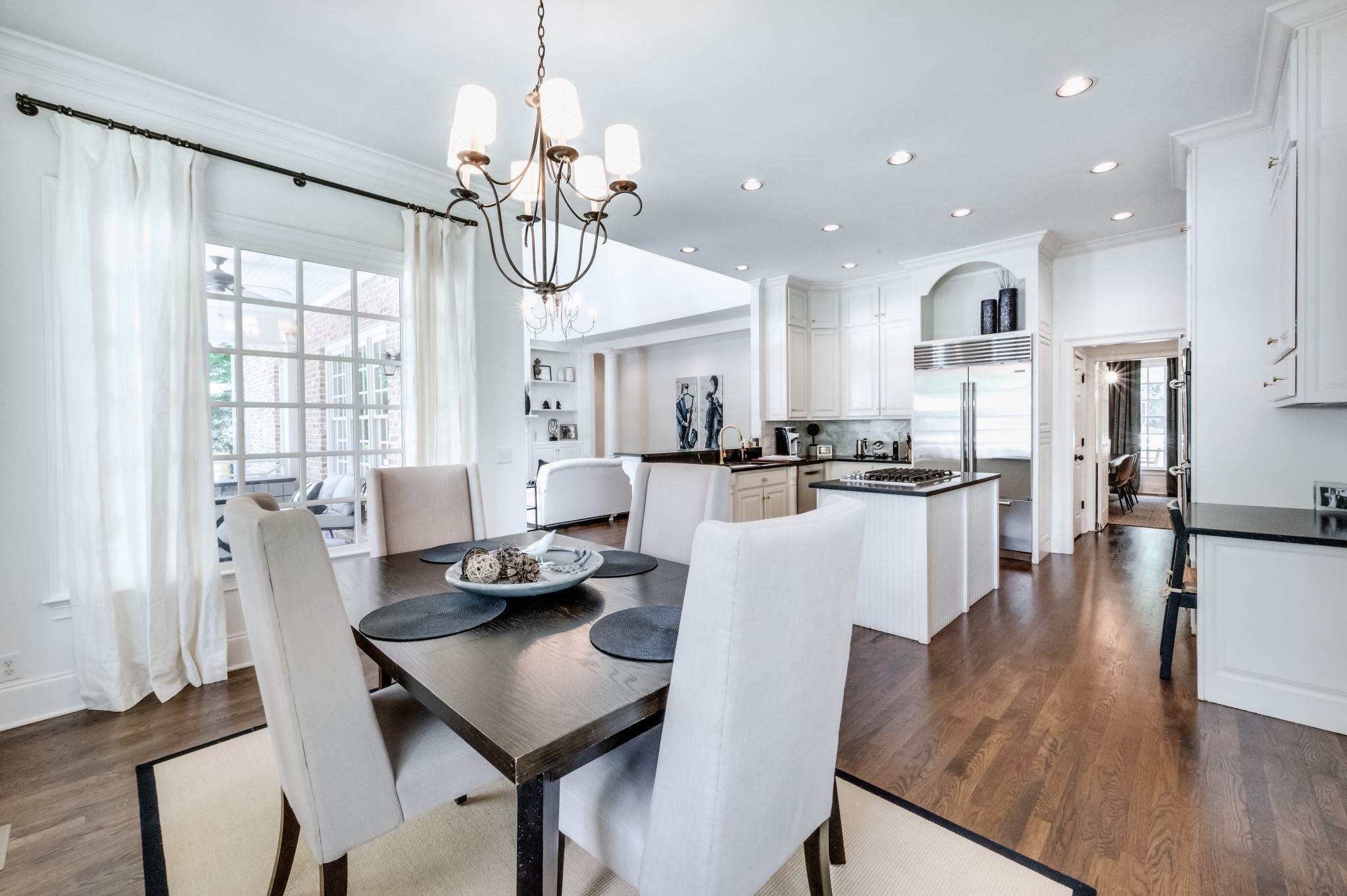114 Cheek Road Nashville, TN 37205 - Photo 18 of 50 a view of a dining room and livingroom with furniture wooden floor a chandelier