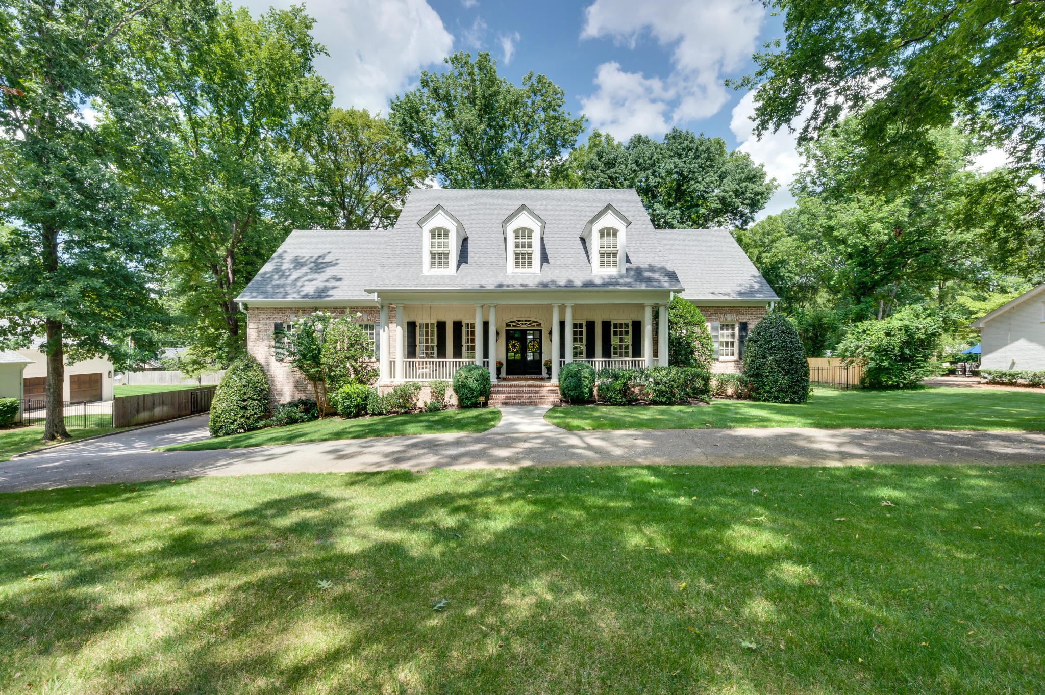 114 Cheek Road Nashville, TN 37205 - Photo 3 of 50 a front view of a house with a yard