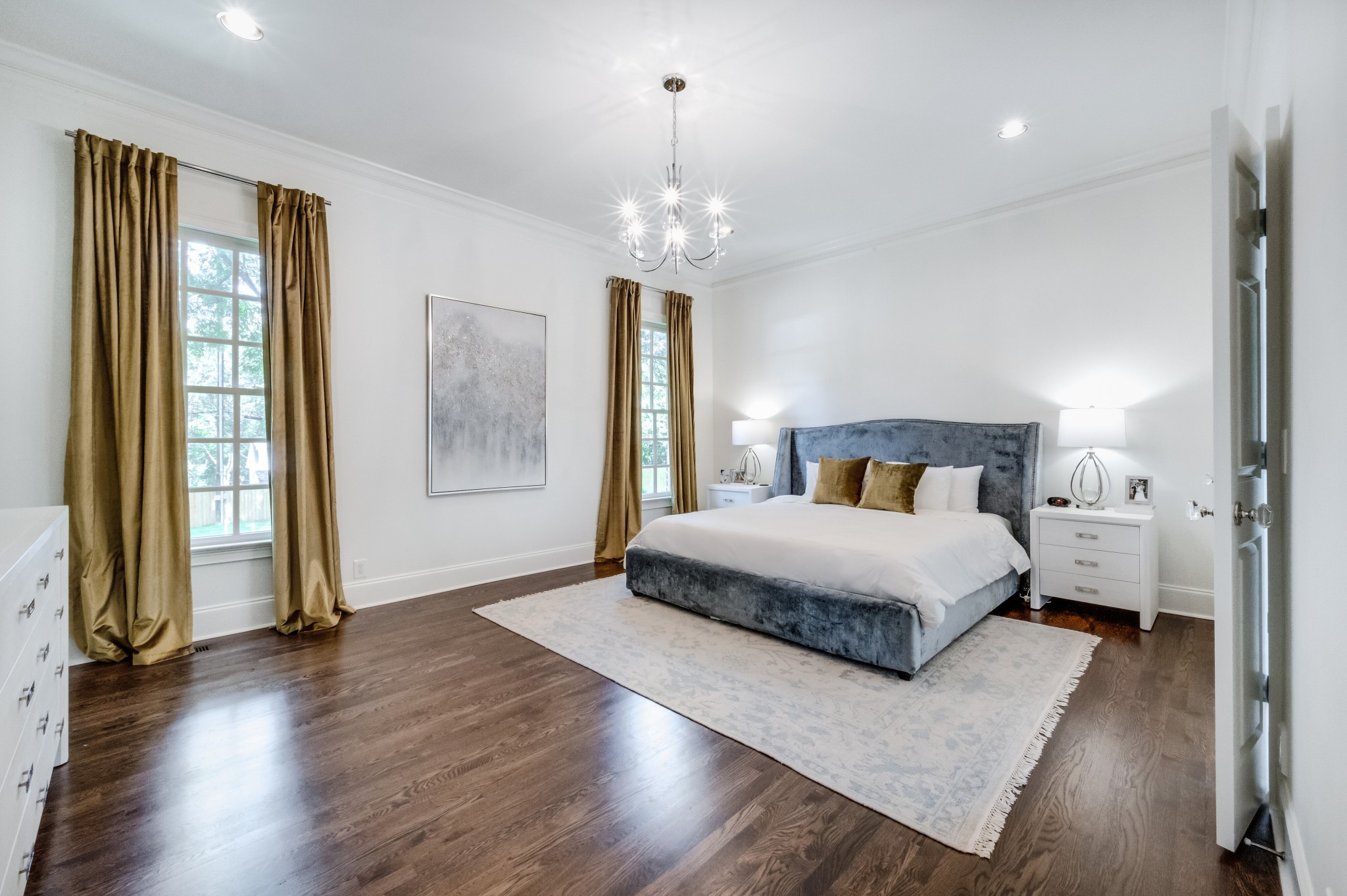 114 Cheek Road Nashville, TN 37205 - Photo 24 of 50 a bedroom with a large bed and a chandelier