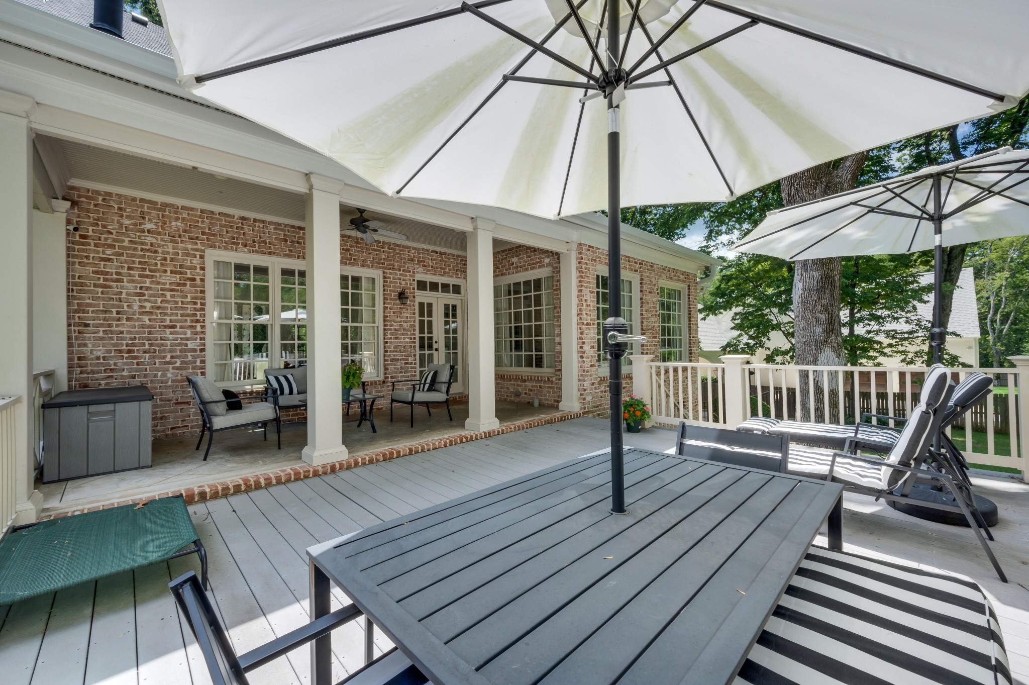 114 Cheek Road Nashville, TN 37205 - Photo 42 of 50 a view of a roof deck with a table and chairs under an umbrella