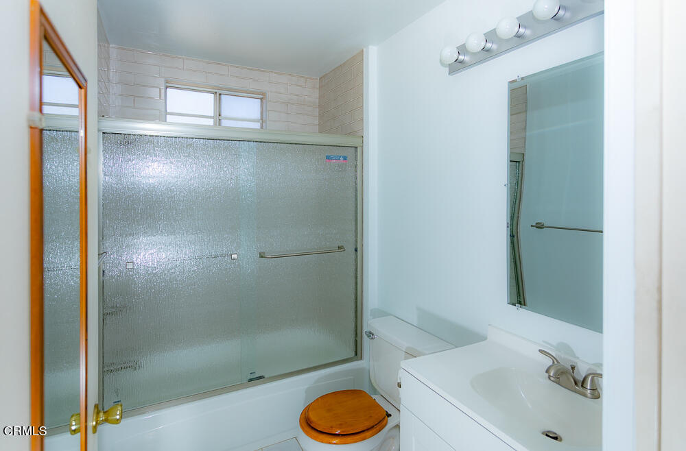 10433 Plainview Avenue, Unit 4 Tujunga, CA 91042 - Photo 20 of 27 a bathroom with a sink toilet and shower