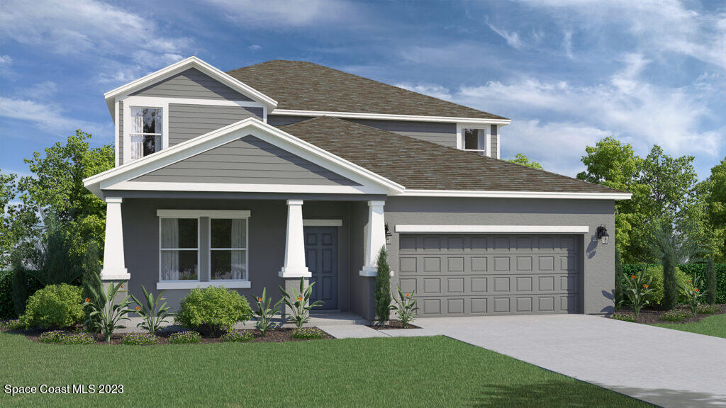 a front view of a house with a garden and yard