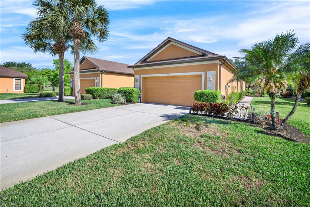 3732 Costa Maya Way Estero, FL 33928 - Photo 17 of 19 a front view of a house with a yard and garage
