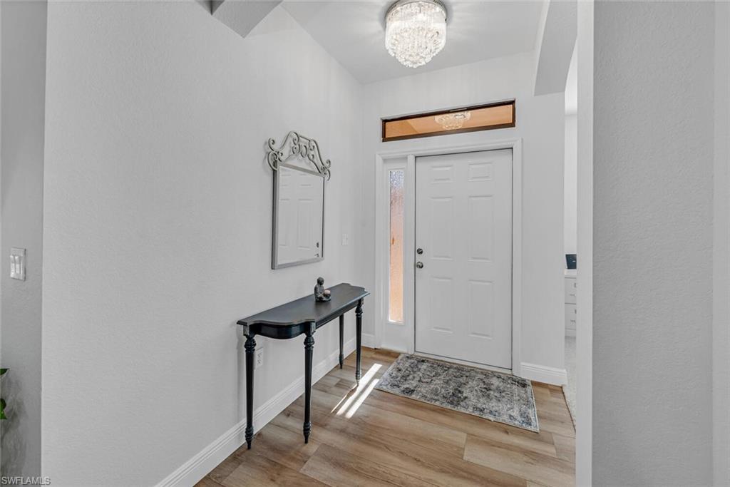 3732 Costa Maya Way Estero, FL 33928 - Photo 2 of 19 a room with wooden floor and mirror