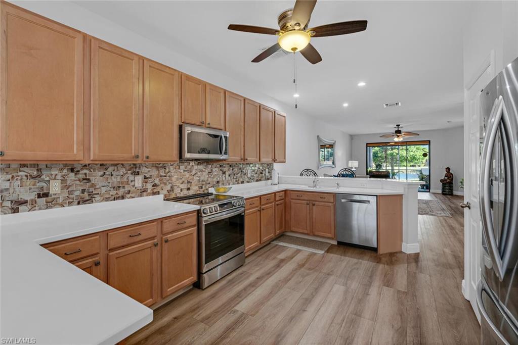 3732 Costa Maya Way Estero, FL 33928 - Photo 3 of 19 a large kitchen with stainless steel appliances granite countertop a stove a sink dishwasher and a refrigerator