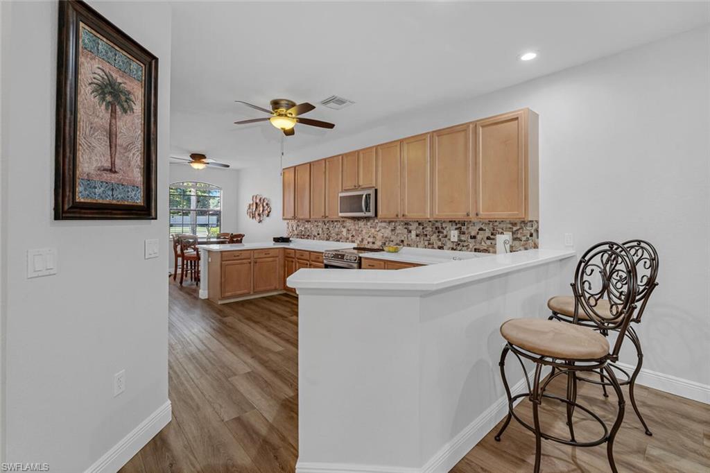 3732 Costa Maya Way Estero, FL 33928 - Photo 4 of 19 a living room with stainless steel appliances furniture a chandelier and a view of kitchen