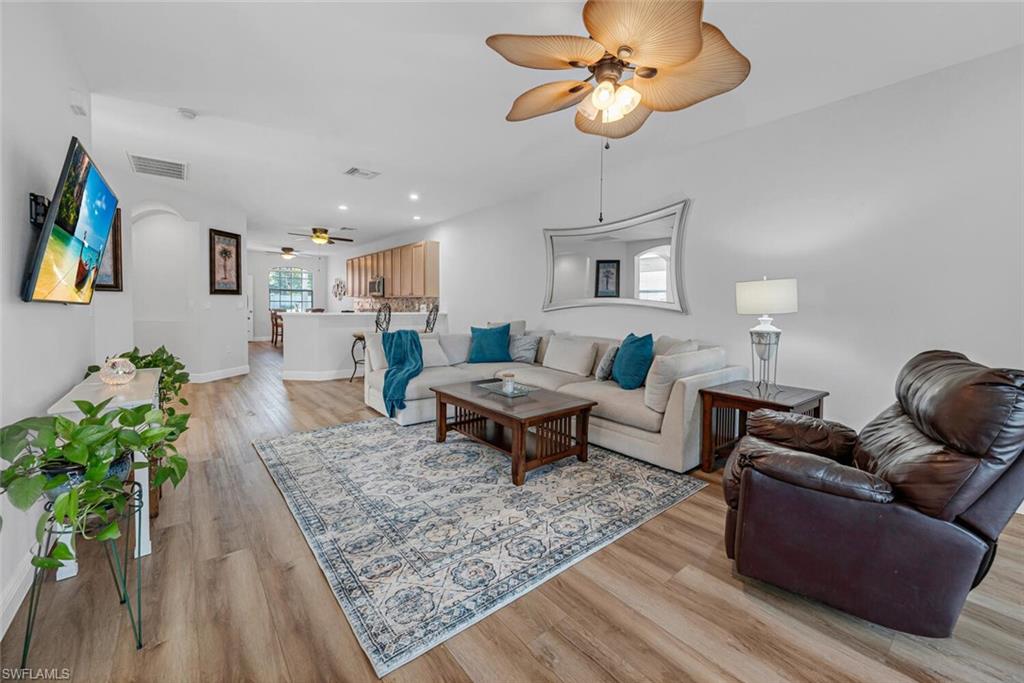 3732 Costa Maya Way Estero, FL 33928 - Photo 7 of 19 a living room with furniture a rug and a chandelier