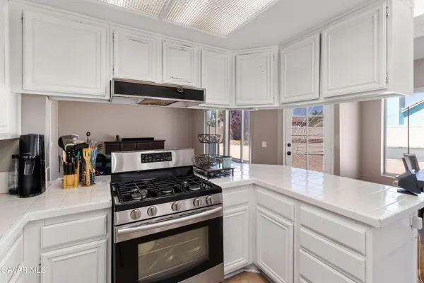 a kitchen with cabinets appliances and a counter space