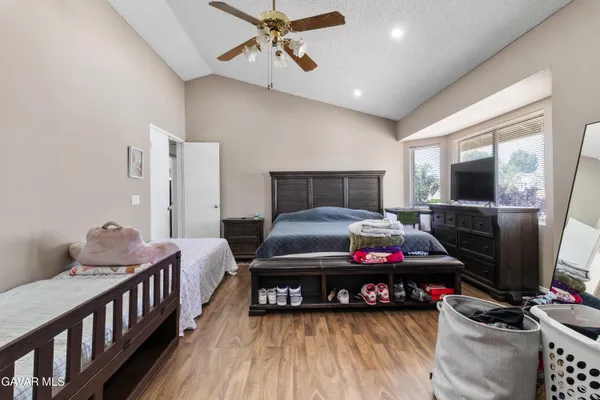 a bedroom with furniture and wooden floor