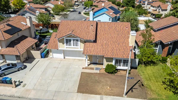 an aerial view of a house with a yard