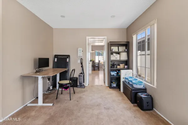 a view of room with workspace and windows