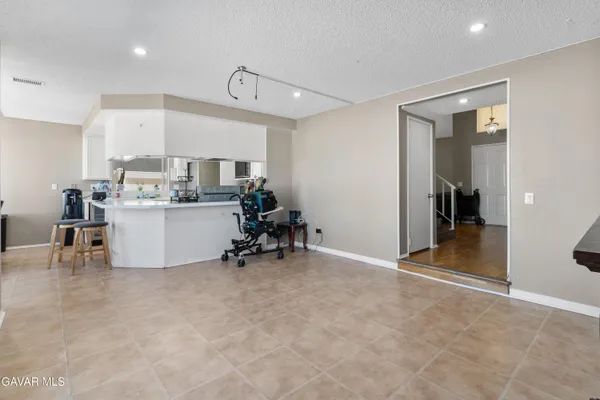 a view of a kitchen with furniture and a refrigerator