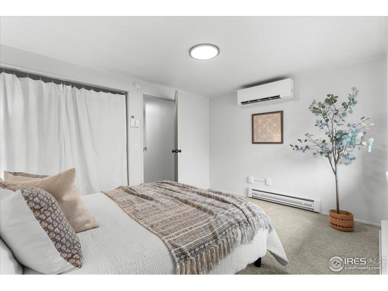 1200 Pomona Street, Unit Q & R Fort Collins, CO 80521 - Photo 22 of 32 a bedroom with a large bed and a chandelier