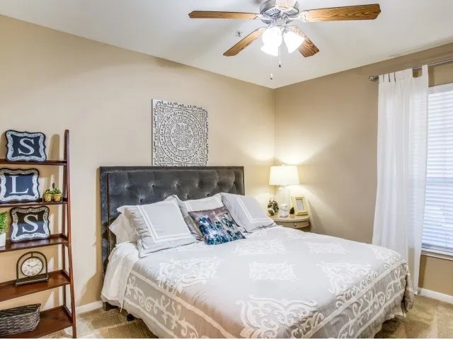 10221 Centrepark Drive, Unit A824 Houston, TX 77043 - Photo 7 of 16 a bedroom with a bed and a chandelier