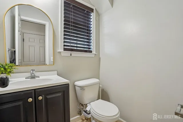 a bathroom with a sink a toilet and mirror