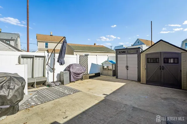 a view of a bedroom with wooden floor and furniture