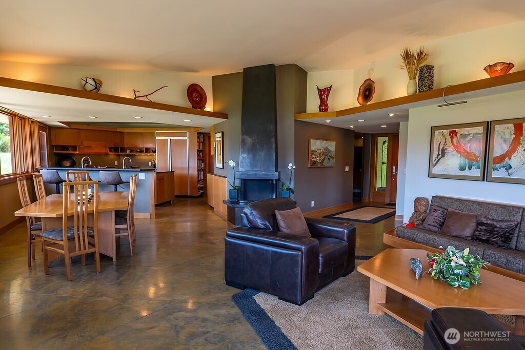 2000 Bayshore Road Lopez Island, WA 98261 - Photo 6 of 40 a living room with furniture and a dining table with kitchen view
