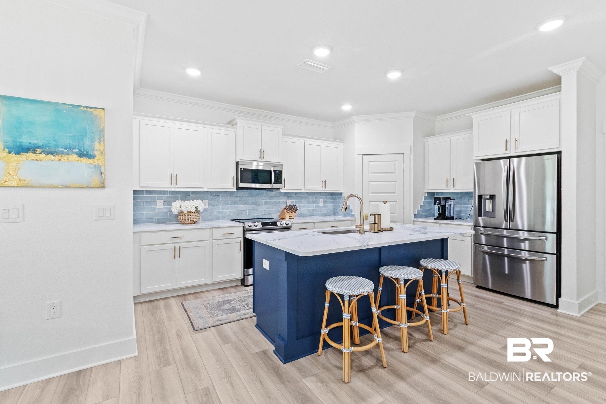 9815 Lakeview Drive Foley, AL 36535 - Photo 20 of 100 Kitchen with backsplash, white cabinetry, stainless steel appliances, and light hardwood / wood-style floors